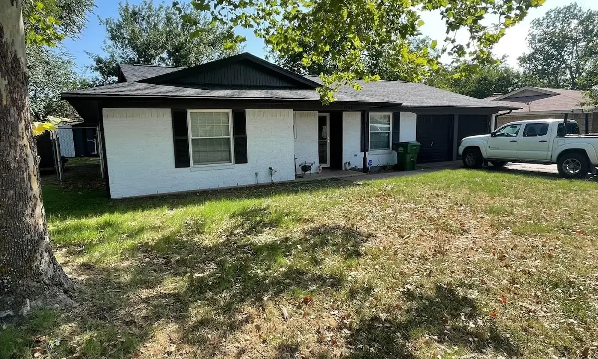 Professional roofing crew working on a residential roof in Fredonia